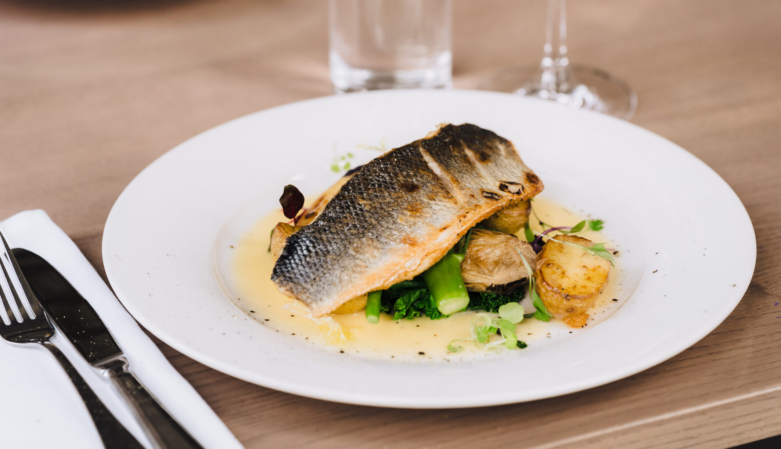 Fillet of seabass (NGCI) artichoke, fennel, kale, garlic new potatoes, lemon beurre blanc